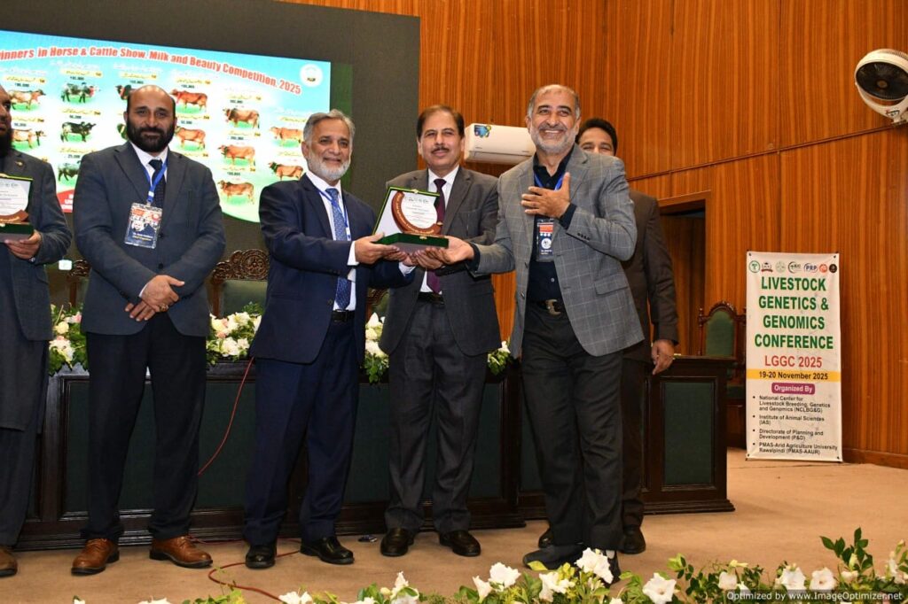 Dr. Raziq eceiving award from the organizers of the conference